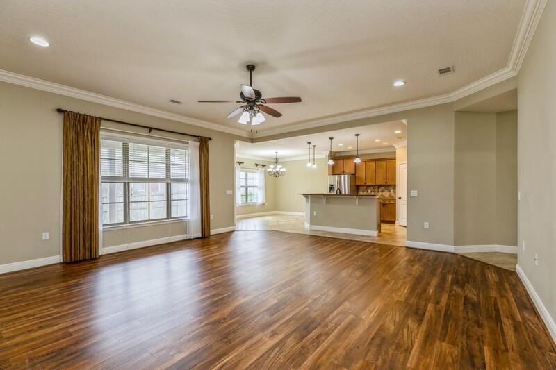 4609 Hermosa Road Crestview, FL 32539 - Photo 7 of 34 a view of an empty room with window and wooden floor