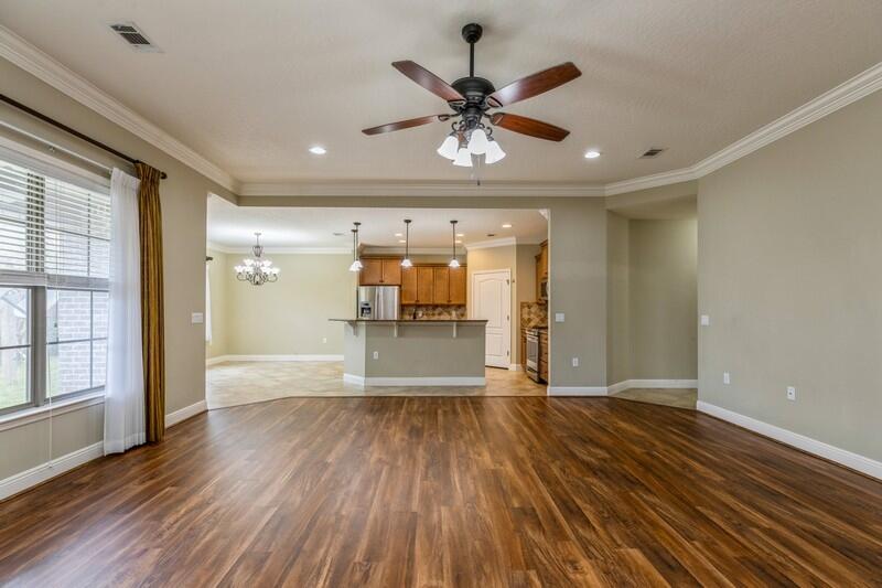 4609 Hermosa Road Crestview, FL 32539 - Photo 8 of 34 a view of an empty room with wooden floor and a window