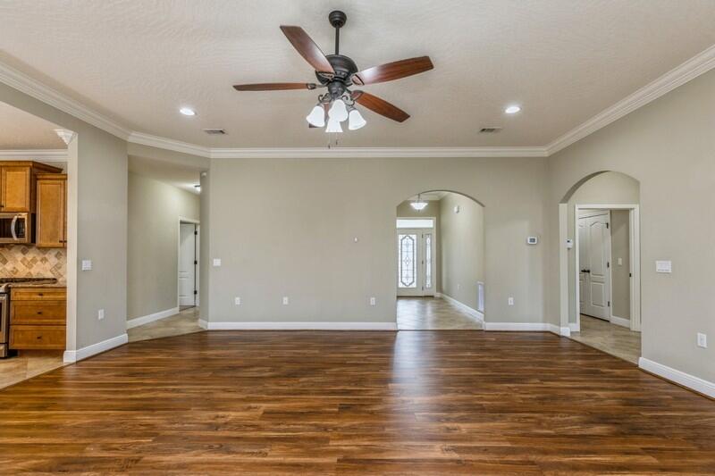 4609 Hermosa Road Crestview, FL 32539 - Photo 9 of 34 wooden floor in an empty room with a window