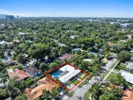 an aerial view of residential house with outdoor space and trees