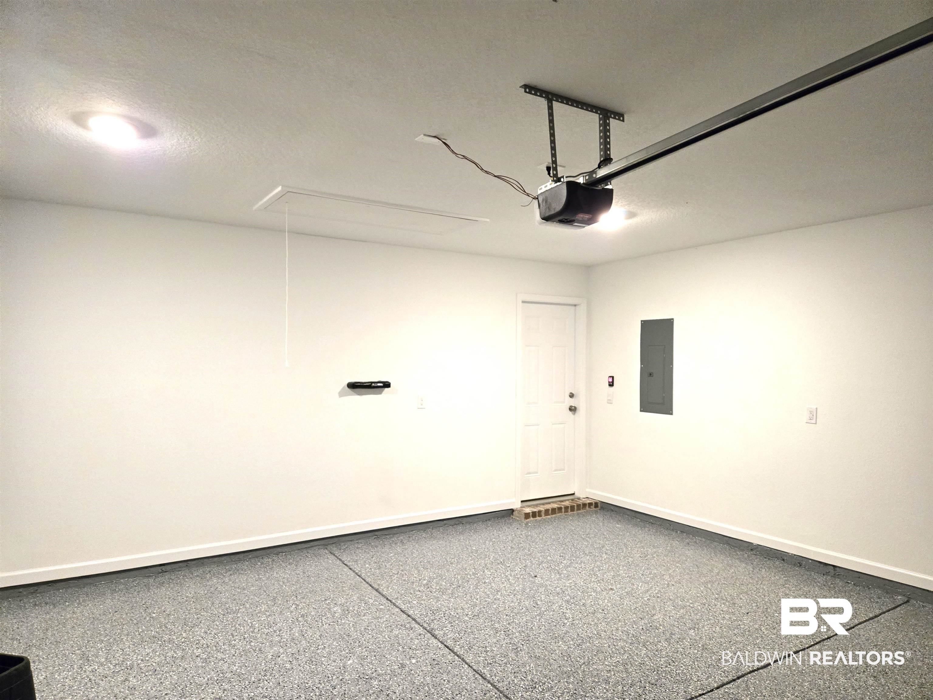 24321 Ringneck Loop Elberta, AL 36530 - Photo 35 of 39 Garage with a garage door opener and electric panel