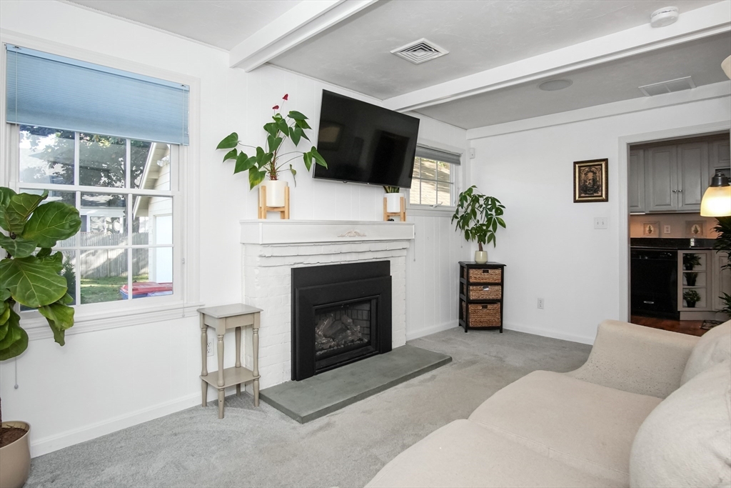 77 Circuit Avenue Wareham, MA 02571 - Photo 17 of 39 a living room with furniture a fireplace and a flat screen tv