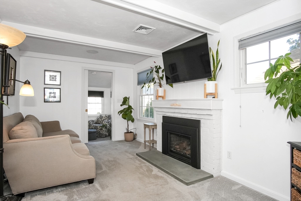 77 Circuit Avenue Wareham, MA 02571 - Photo 18 of 39 a living room with furniture a flat screen tv and a fireplace