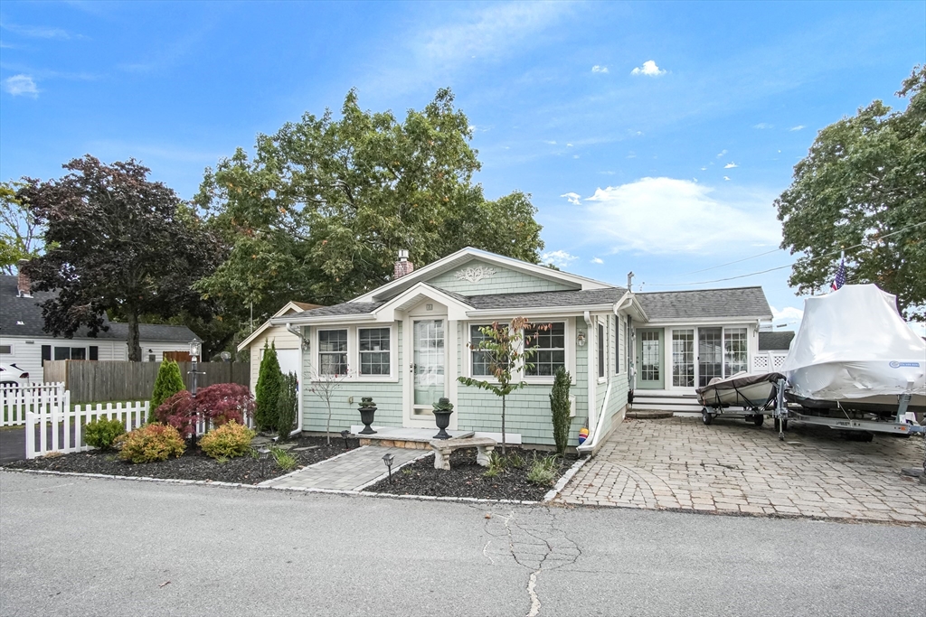 77 Circuit Avenue Wareham, MA 02571 - Photo 2 of 39 a front view of a house with a garden and plants