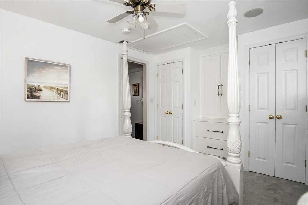 77 Circuit Avenue Wareham, MA 02571 - Photo 21 of 39 a bedroom with a bed and a chandelier