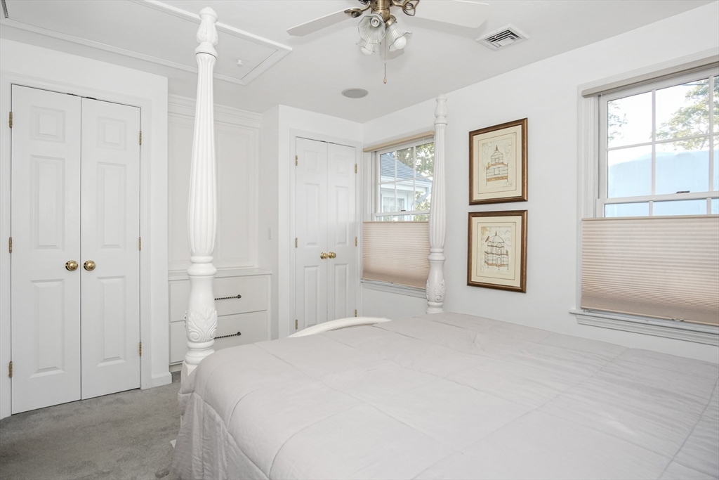 77 Circuit Avenue Wareham, MA 02571 - Photo 22 of 39 a spacious bedroom with a bed and a chandelier