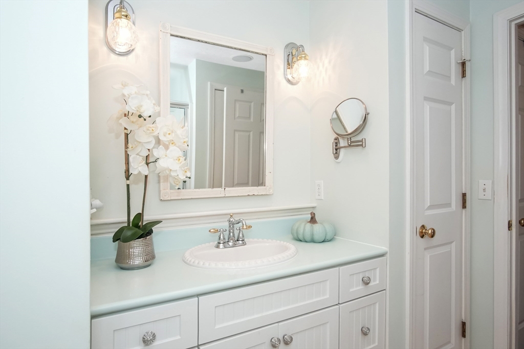 77 Circuit Avenue Wareham, MA 02571 - Photo 25 of 39 a bathroom with cabinets a sink and a mirror