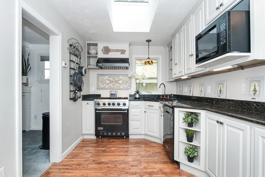 77 Circuit Avenue Wareham, MA 02571 - Photo 6 of 39 a kitchen with stainless steel appliances granite countertop a stove a sink and a microwave