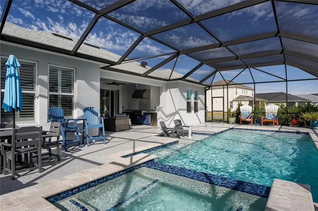 a living room with furniture a flat screen tv and a floor to ceiling window