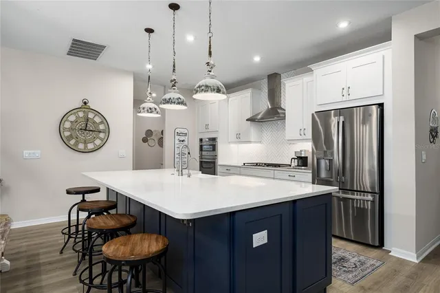 an aerial view of a house with a garden and lake view