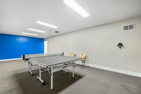 a room with furniture and air conditioner vent