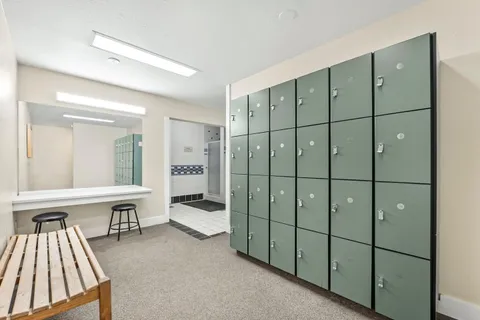 a bathroom with a shower a sink and a mirror