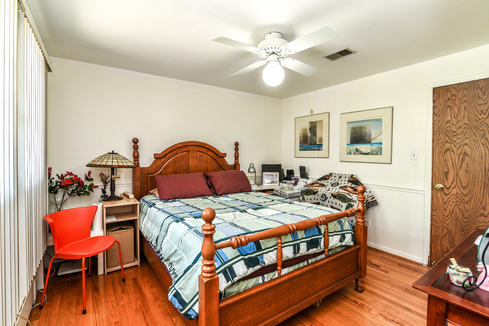 5149 State Road Burbank, IL 60459 - Photo 17 of 36 a bedroom with a bed a dresser and wooden floor