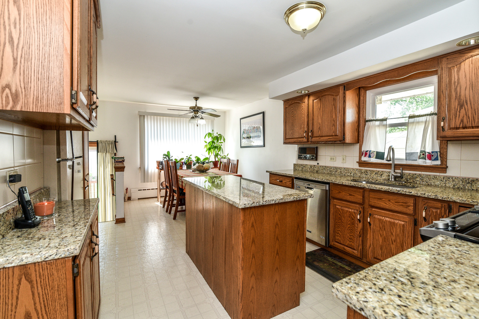5149 State Road Burbank, IL 60459 - Photo 7 of 36 a kitchen with stainless steel appliances granite countertop sink stove and refrigerator