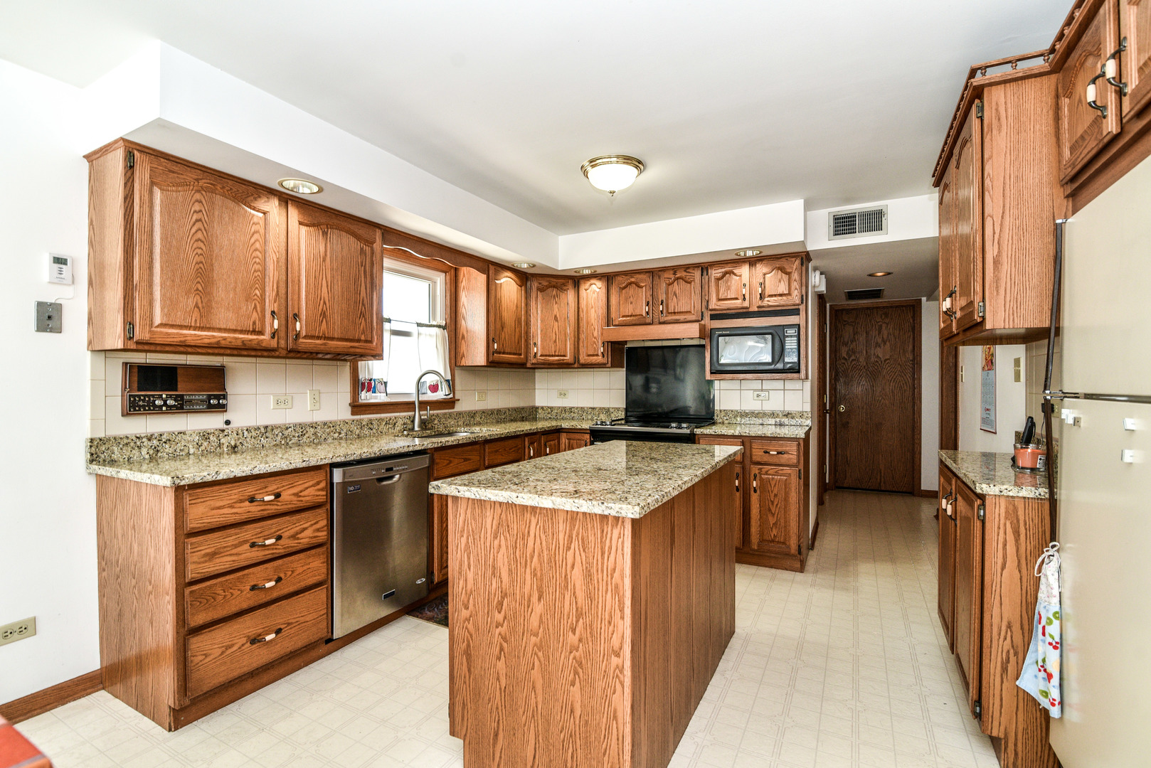 5149 State Road Burbank, IL 60459 - Photo 8 of 36 a kitchen with stainless steel appliances granite countertop a stove sink and cabinets