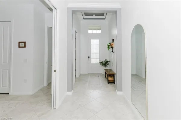 a view of a hallway view with wooden floor and a bathroom