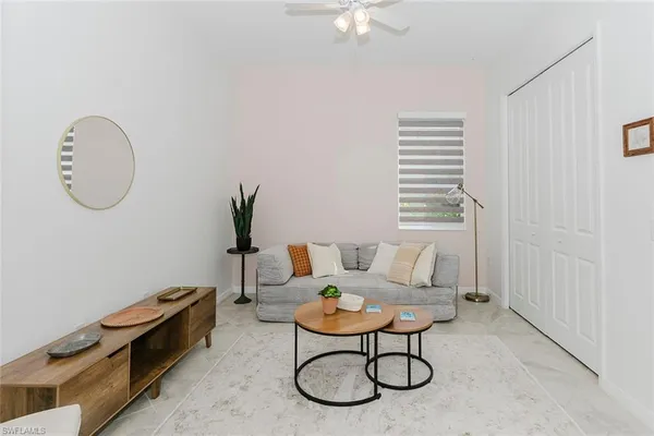 a living room with furniture a table and a window