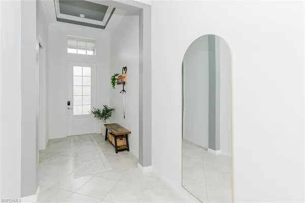 a view of a hallway with entryway and living room