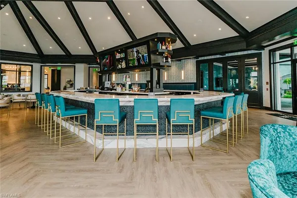 a room with stainless steel appliances kitchen island granite countertop furniture and a view of kitchen