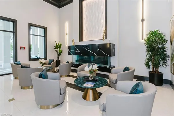 a lobby with furniture and chandelier