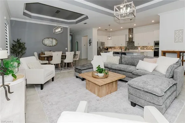 a living room with fireplace furniture and a chandelier