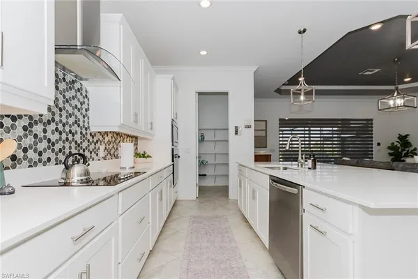 a kitchen with a sink stove and cabinets