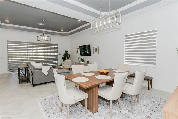 a dining room with furniture and a large window
