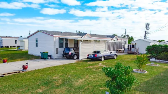 a view of a house with backyard and porch