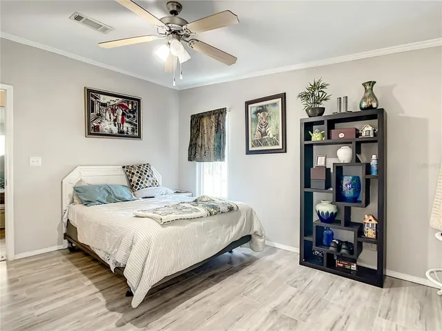 a bedroom with bed and a bookshelf