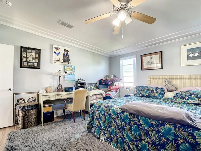a bedroom with bed and a chandelier