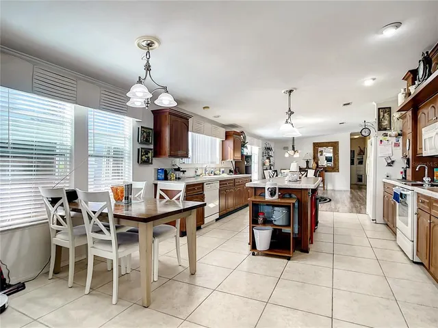 a large kitchen with a table and chairs