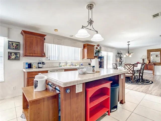 a kitchen with stainless steel appliances granite countertop a sink a stove and a wooden floors