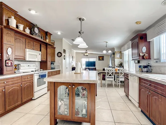 a large kitchen with lots of counter top space and stainless steel appliances
