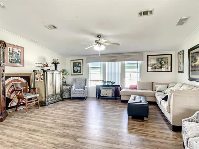 a living room with furniture window and a flat screen tv