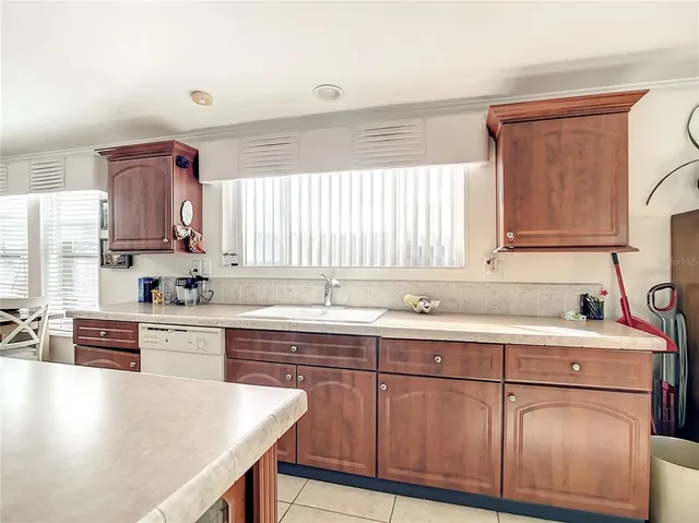 a kitchen with a sink a stove and cabinets