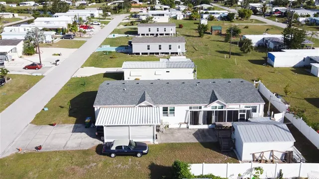 an aerial view of multiple houses with a swimming pool