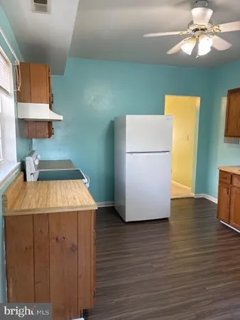 a kitchen with a refrigerator and a stove
