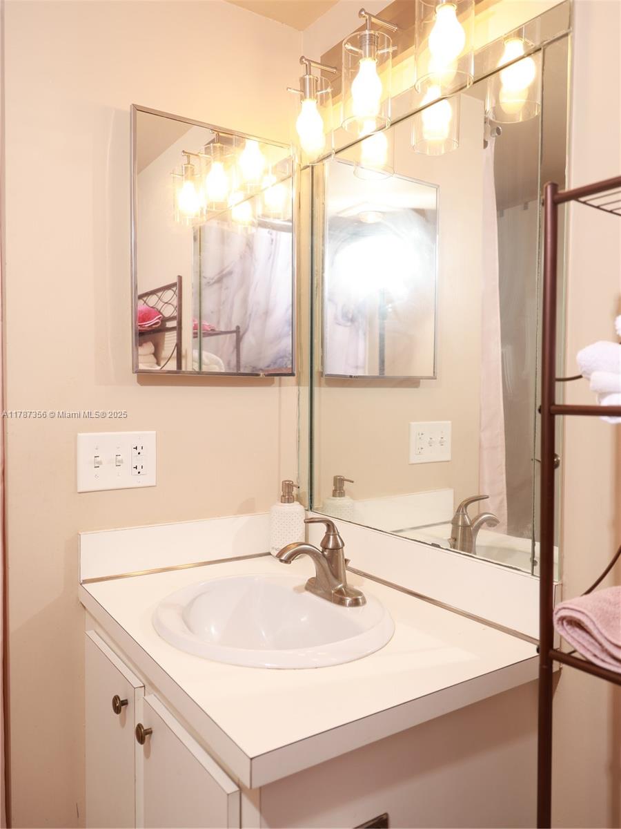 Inverrary Lauderhill, FL 33319 - Photo 15 of 24 a bathroom with a sink and a mirror