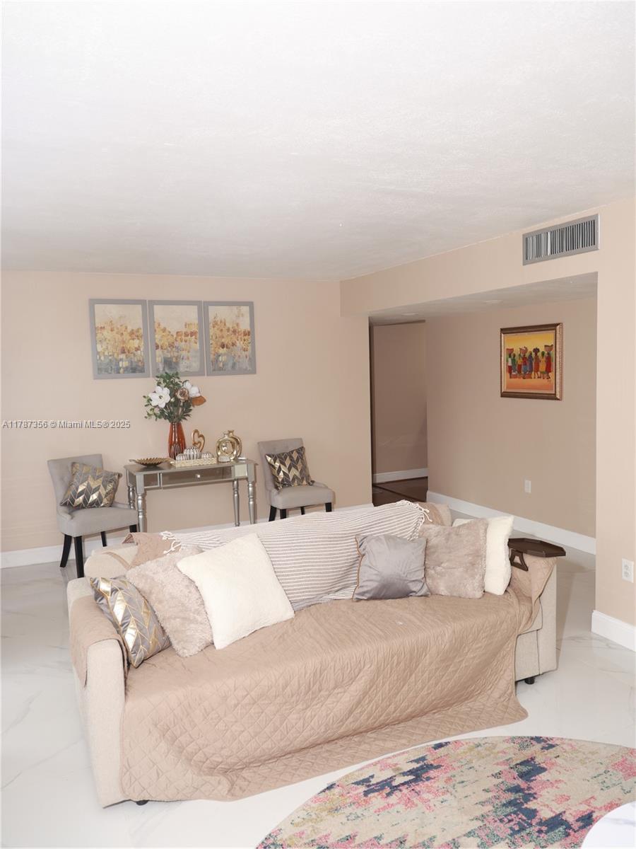 Inverrary Lauderhill, FL 33319 - Photo 17 of 24 a living room with furniture and a lamp