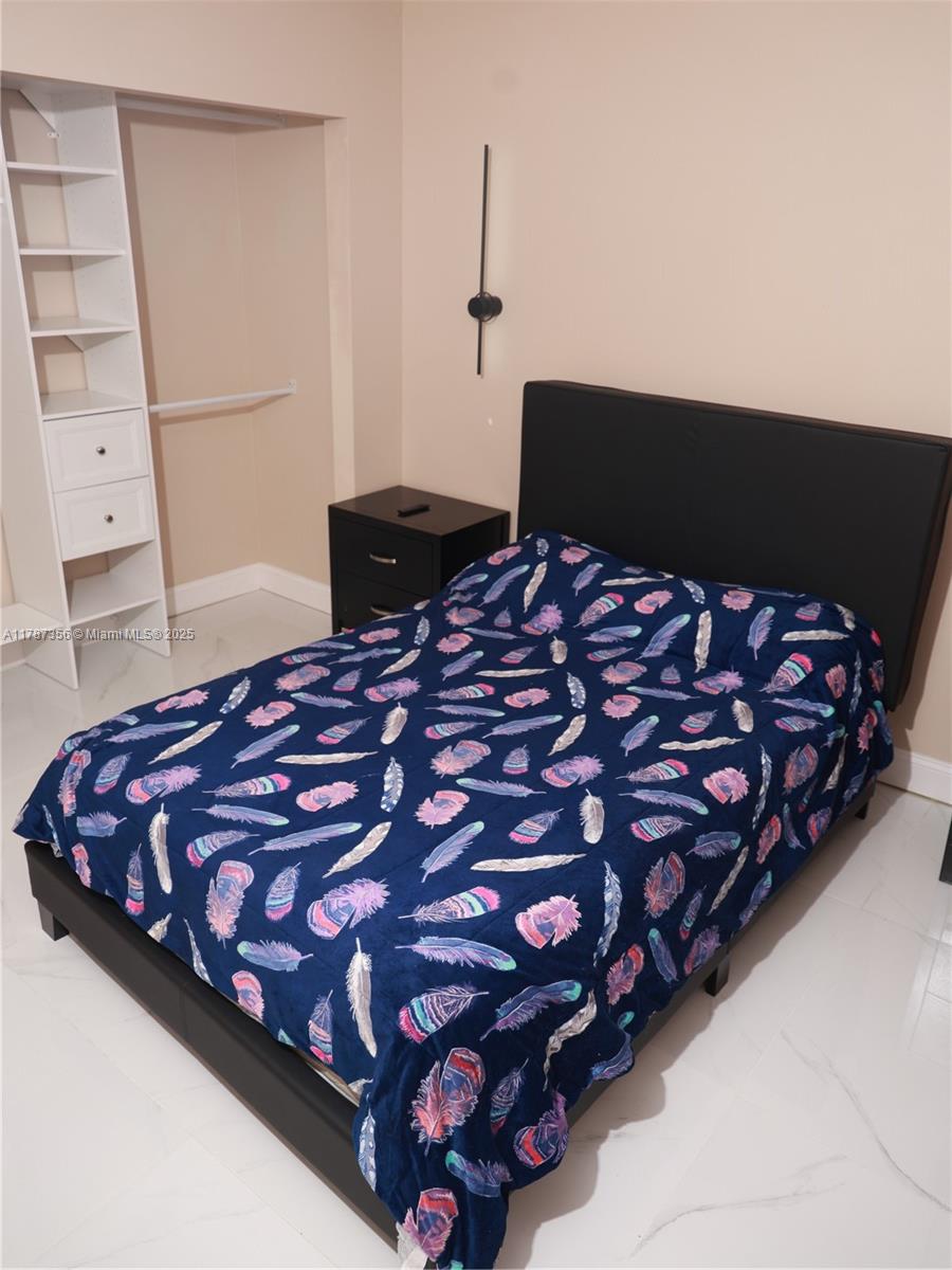 Inverrary Lauderhill, FL 33319 - Photo 18 of 24 a bedroom with a bed and a night stand