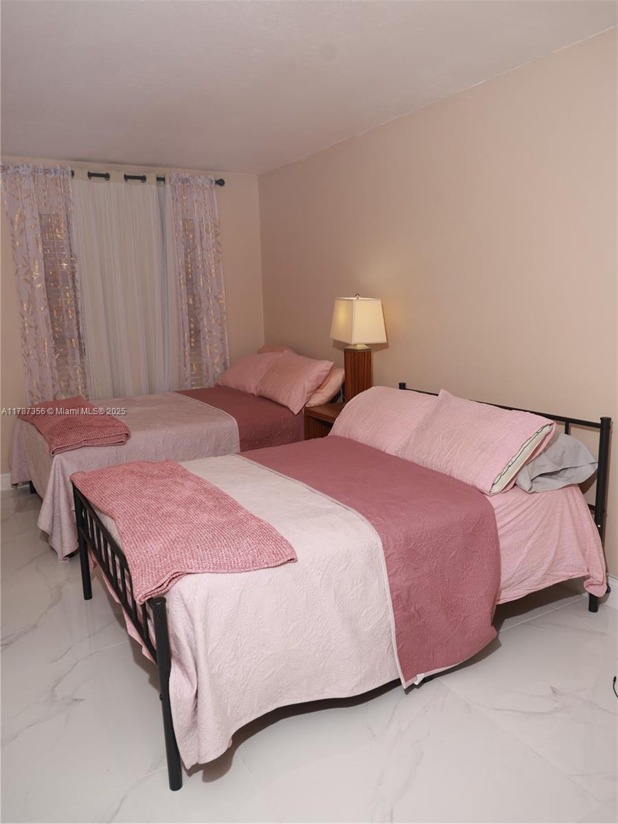 Inverrary Lauderhill, FL 33319 - Photo 5 of 24 a bedroom with two beds and curtain