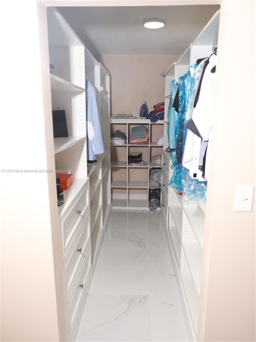 Inverrary Lauderhill, FL 33319 - Photo 6 of 24 walk in closet with window and hardwood floor