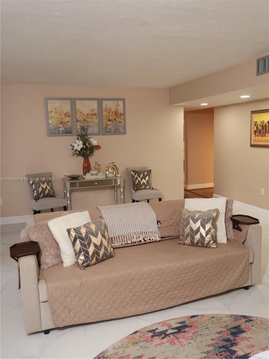 Inverrary Lauderhill, FL 33319 - Photo 9 of 24 a bedroom with a bed and couch