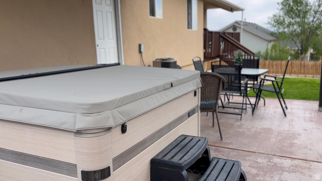 1797 Sunset Road Enoch, UT 84721 - Photo 54 of 80 Outdoor spa with integrated steps, set on a concrete patio