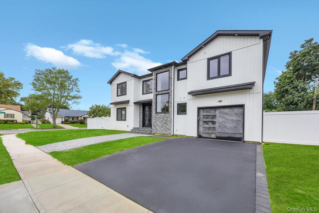 472 Farm Ranch Road East Bethpage, NY 11714 - Photo 1 of 40 a front view of a house with a yard and garage