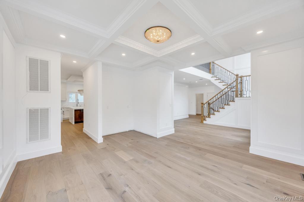 472 Farm Ranch Road East Bethpage, NY 11714 - Photo 11 of 40 Spare room with light wood-style flooring, a chandelier, coffered ceiling, recessed lighting, and beamed ceiling