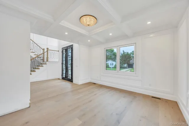 a bathroom with a sink a mirror a toilet and a window
