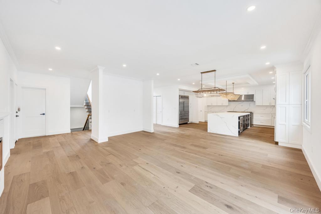 472 Farm Ranch Road East Bethpage, NY 11714 - Photo 14 of 40 Unfurnished living room with light wood-style flooring, crown molding, stairs, and recessed lighting