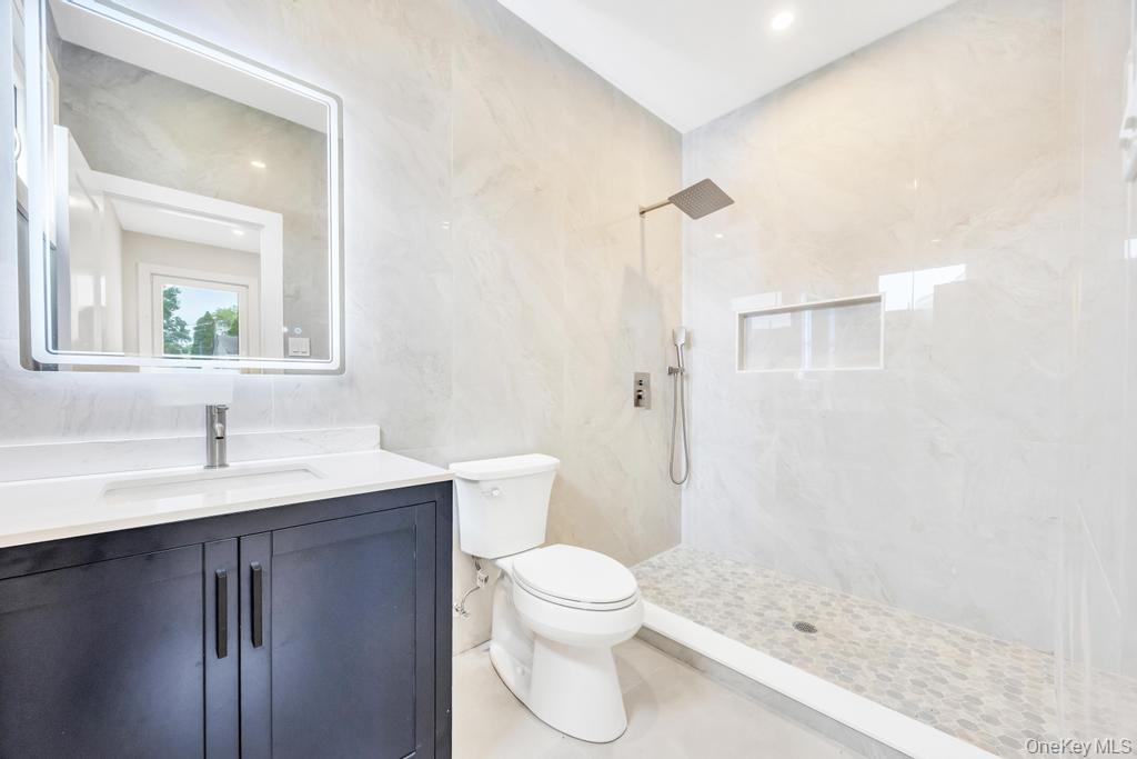 472 Farm Ranch Road East Bethpage, NY 11714 - Photo 17 of 40 a bathroom with a sink a toilet and a mirror
