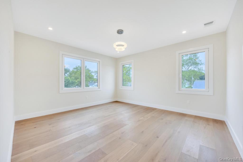 472 Farm Ranch Road East Bethpage, NY 11714 - Photo 20 of 40 an empty room with wooden floor and windows